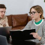 Family Schedules - Man and Woman Discussing in Workplace