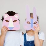 Educational Crafts - Two Kids Covering Their Faces With a Cutout Animal Mask